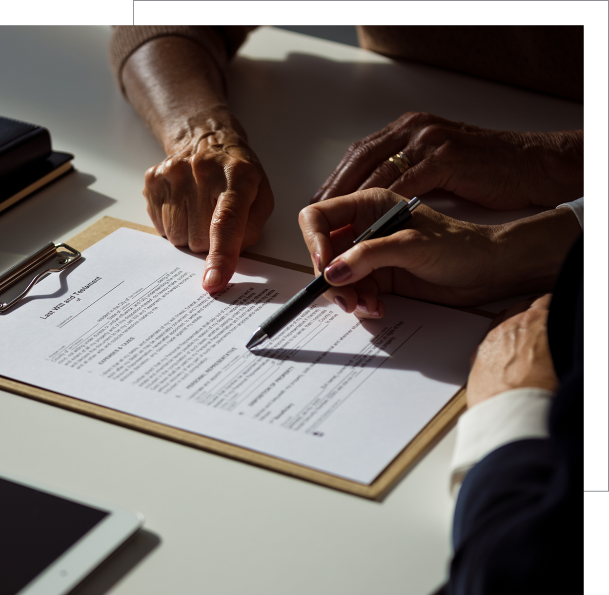 Hands pointing at a contract page