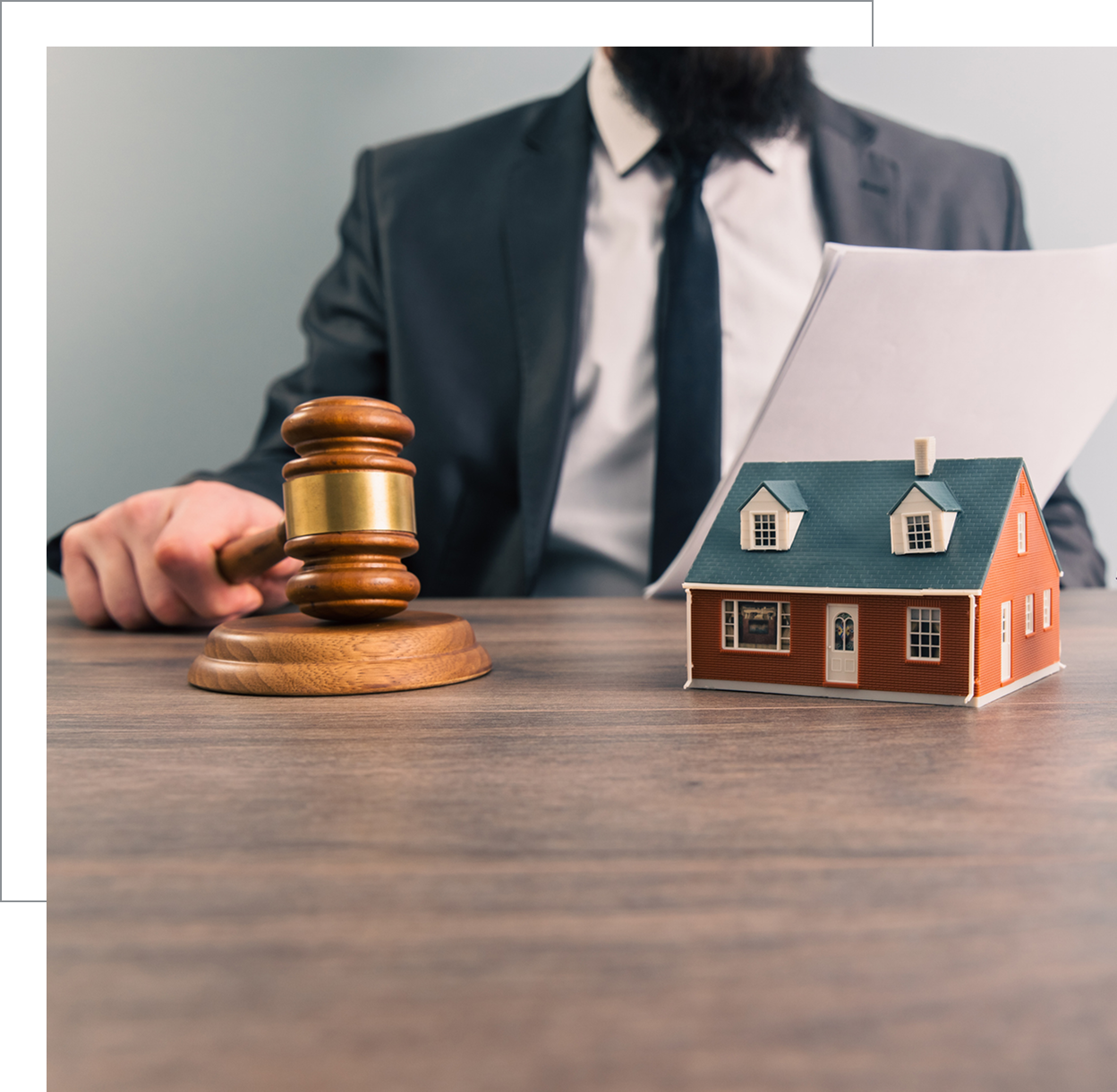Gavel and house model on table