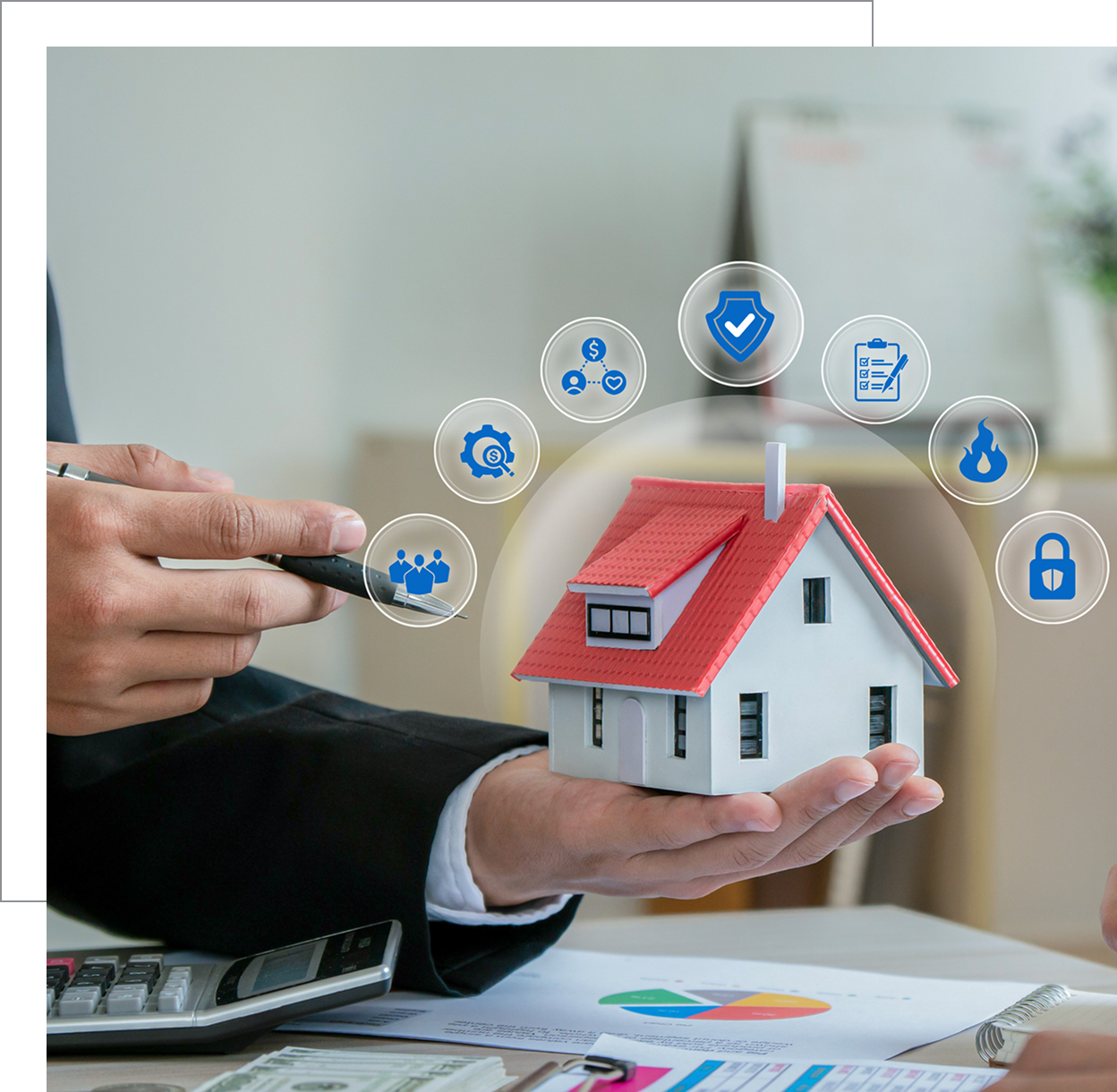 Hand holding miniature house with graphics