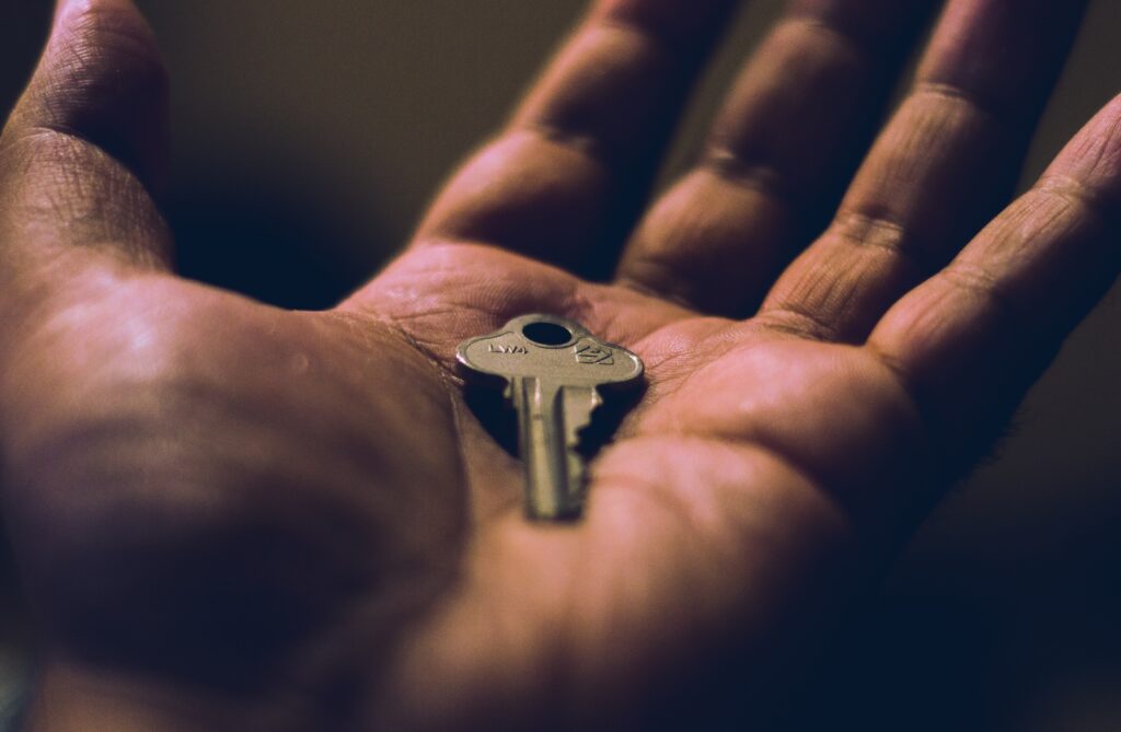 A person holding a key in their hand.