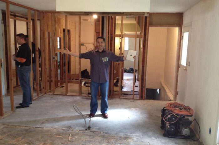 A man standing in a room that is being remodeled.