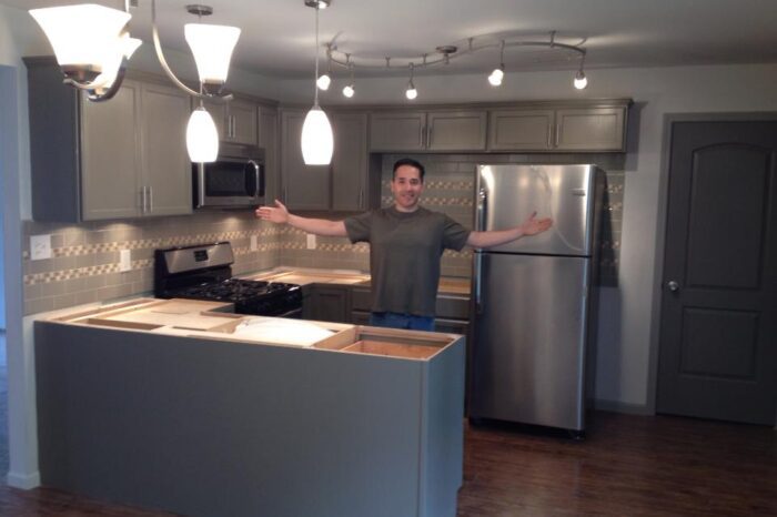 A man standing in front of a kitchen.