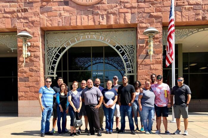 A group of people standing in front of a building.