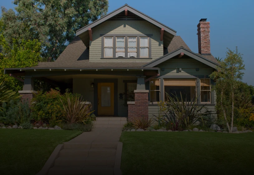 Green house surrounded by trees and plants
