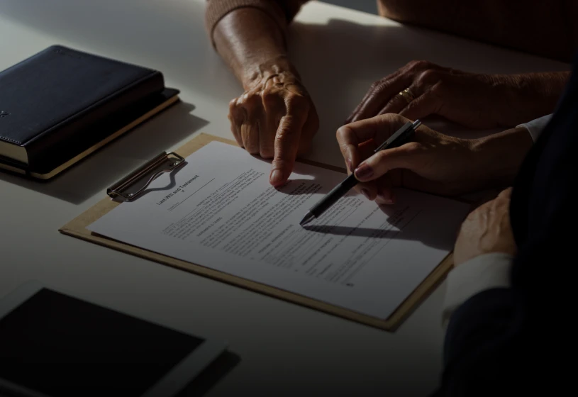 People discussing a contract on clipboard