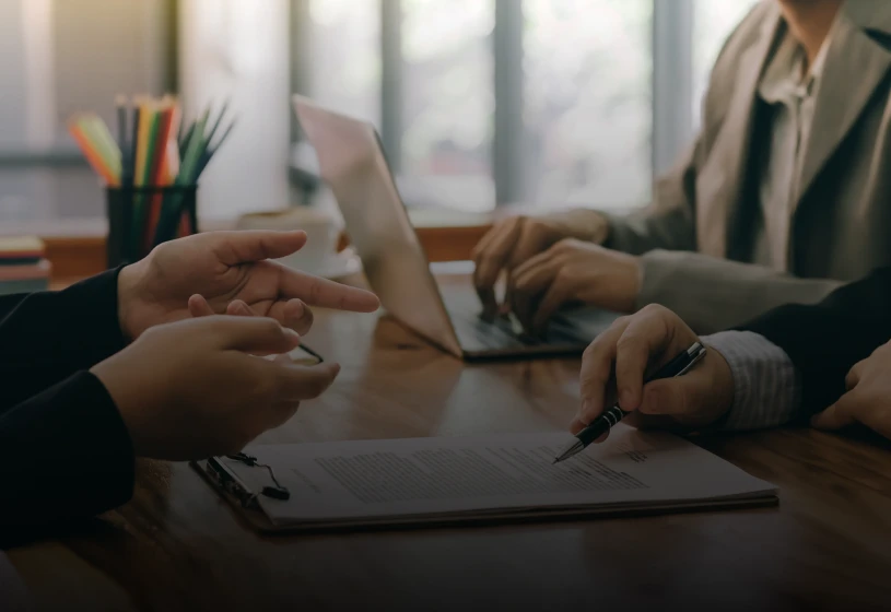 Business meeting with documents and laptop
