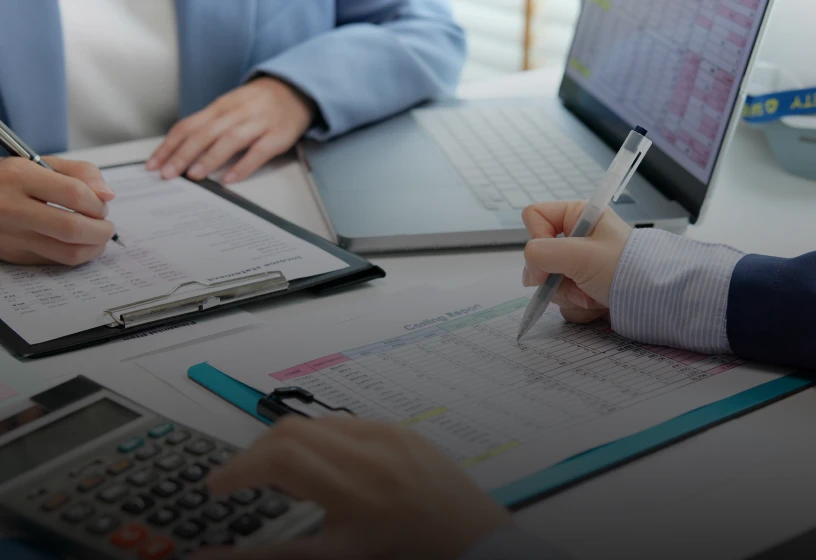 Team analyzing data with calculator